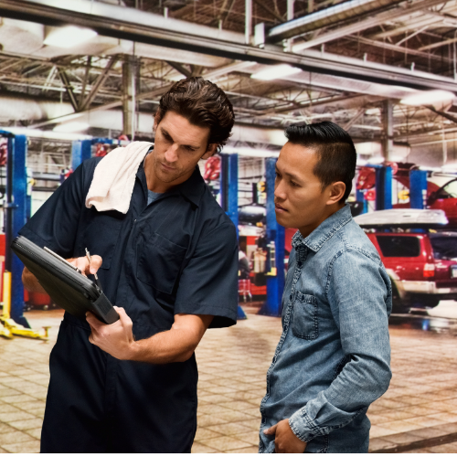 Image showing a garage technician showing the customer a report.